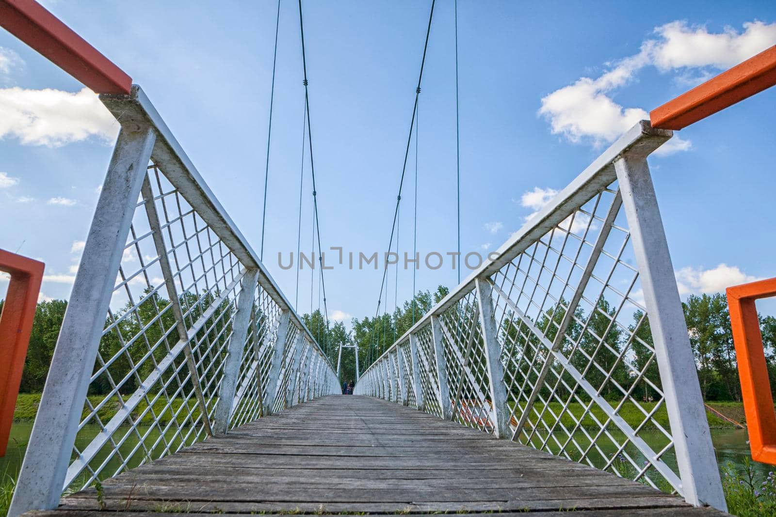 Low view of white suspended bridge by zebra