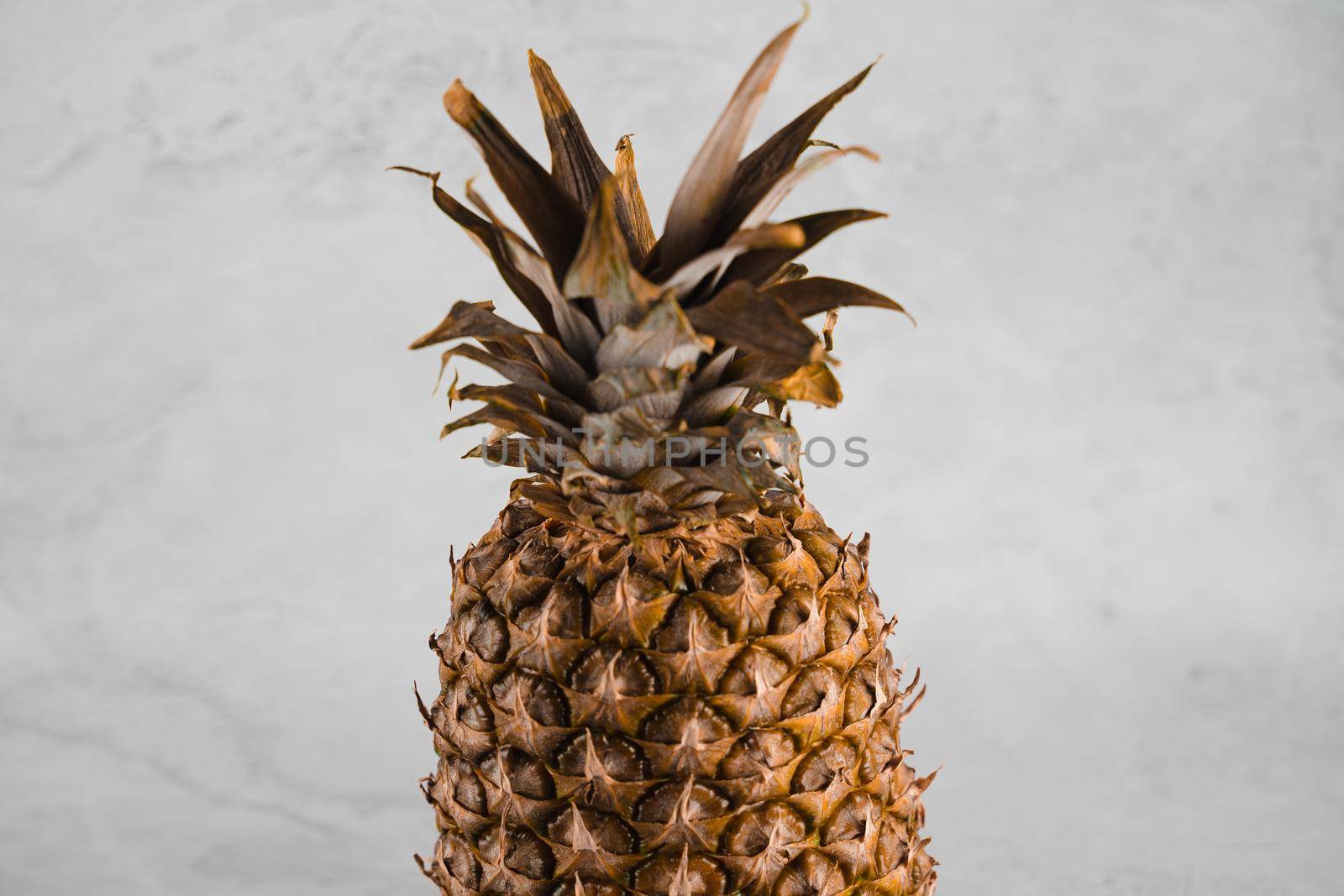 Pineapple tropical fruit on white stone background background. Citrus fruit with vitamin c for helth care. by Rabizo