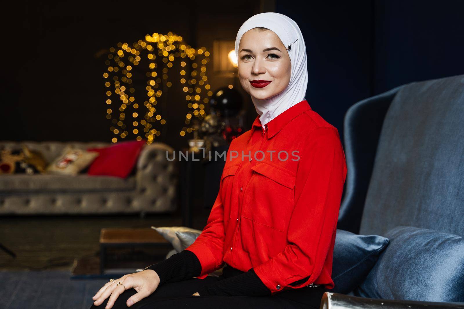 Muslim woman near christmas decoration in studio. Professional muslim model posing at the new year eve.