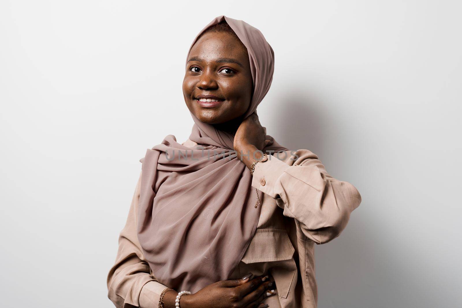 Muslim black girl on white background. African business woman in studio. Model posing. Advert for banking and islamic social media