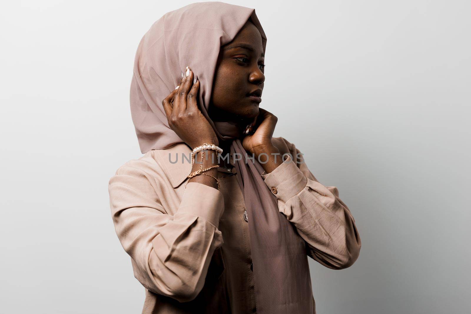 Happy and funny black girl on white background. Young muslim woman smiling in studio. Advert for social network.