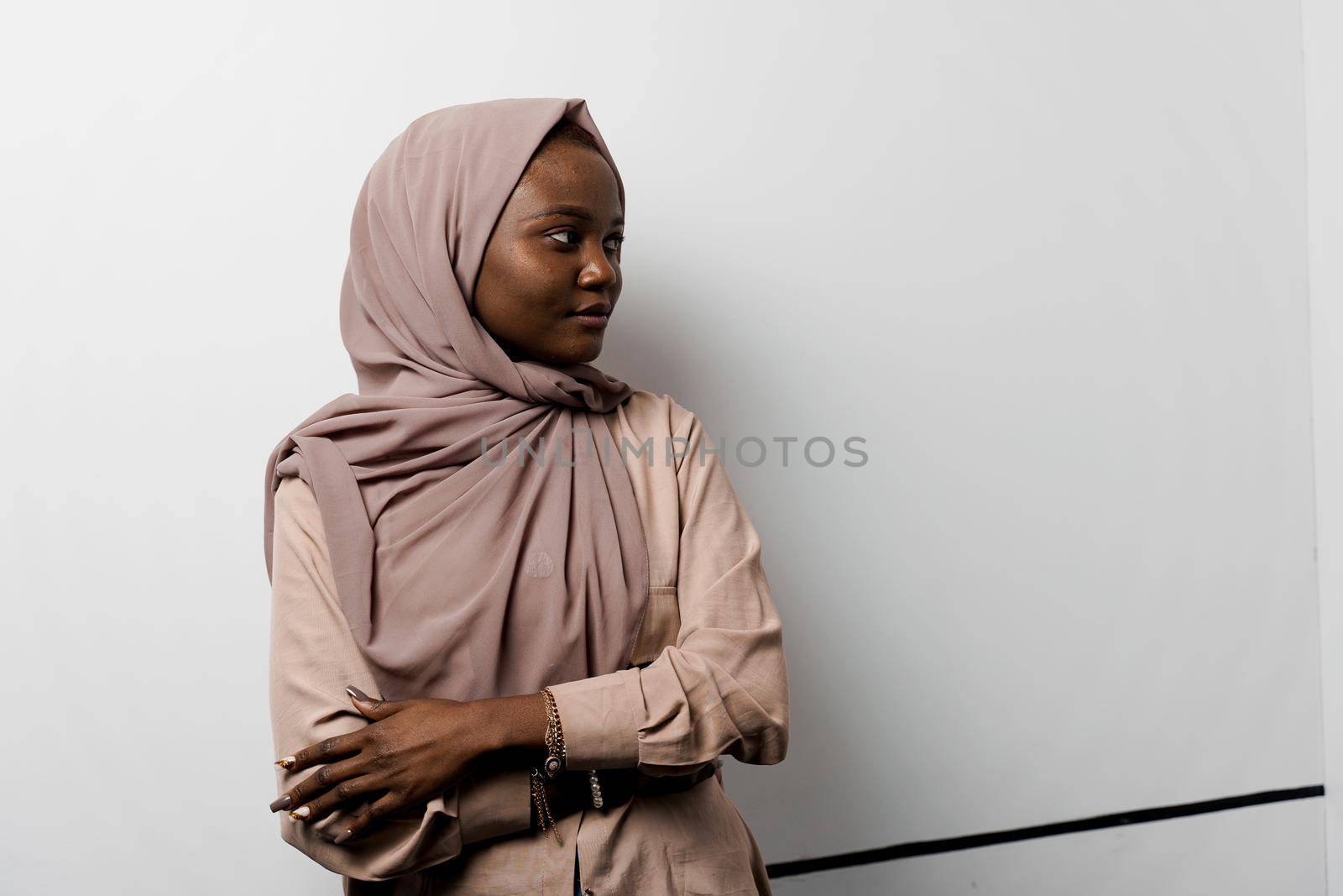 Muslim black girl on white background. African business woman in studio. Model posing. Advert for banking and islamic social media. by Rabizo