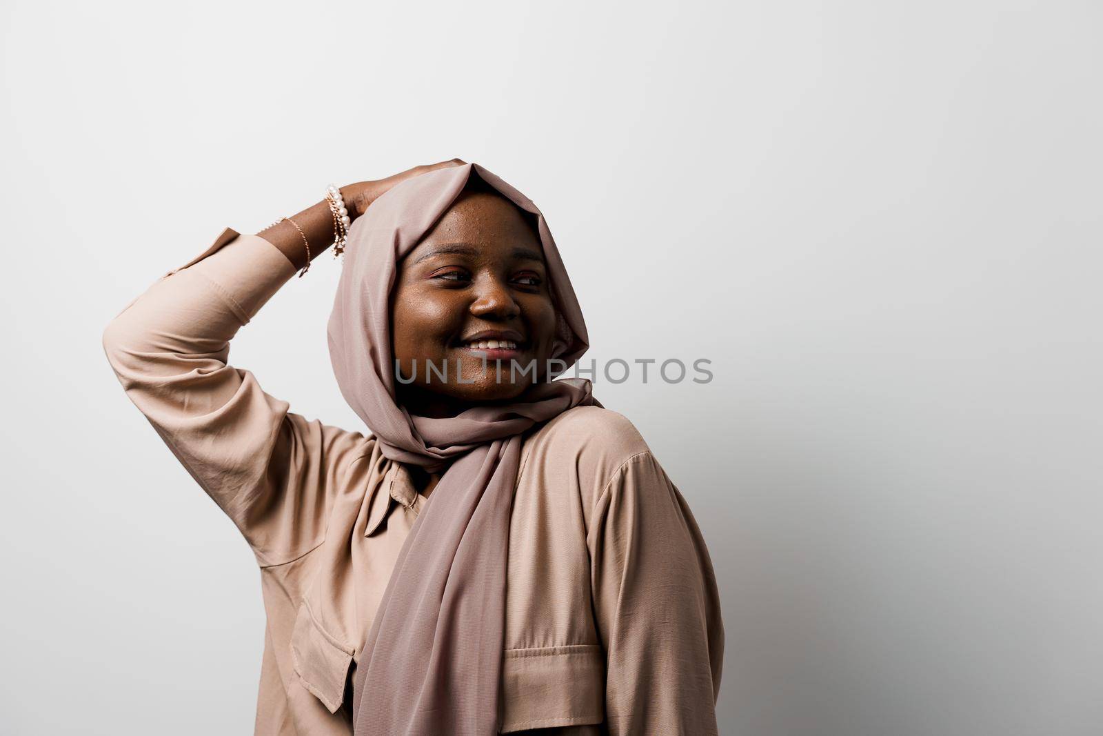 Happy and funny black girl on white background. Young muslim woman smiling in studio. Advert for social network by Rabizo