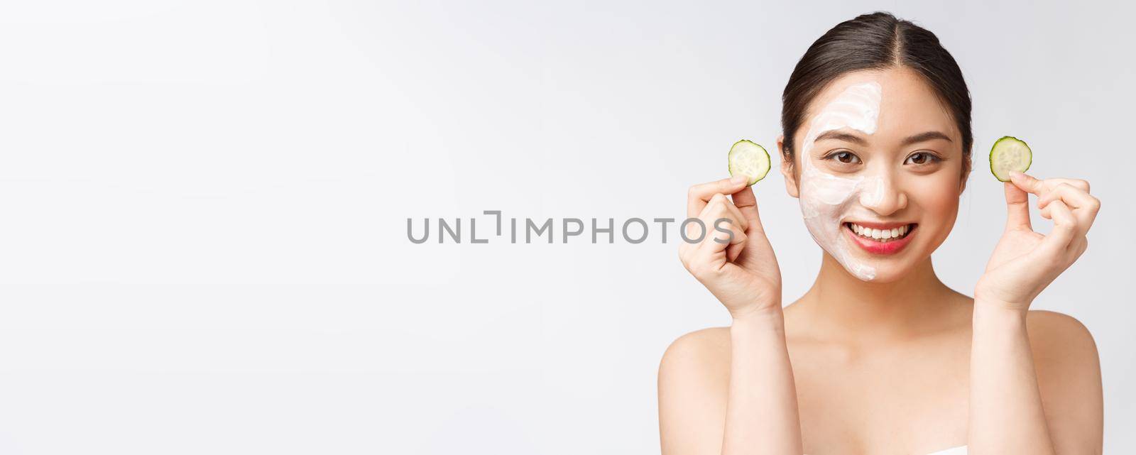 Beauty young asian women skin care image with cucumber on white background studio.