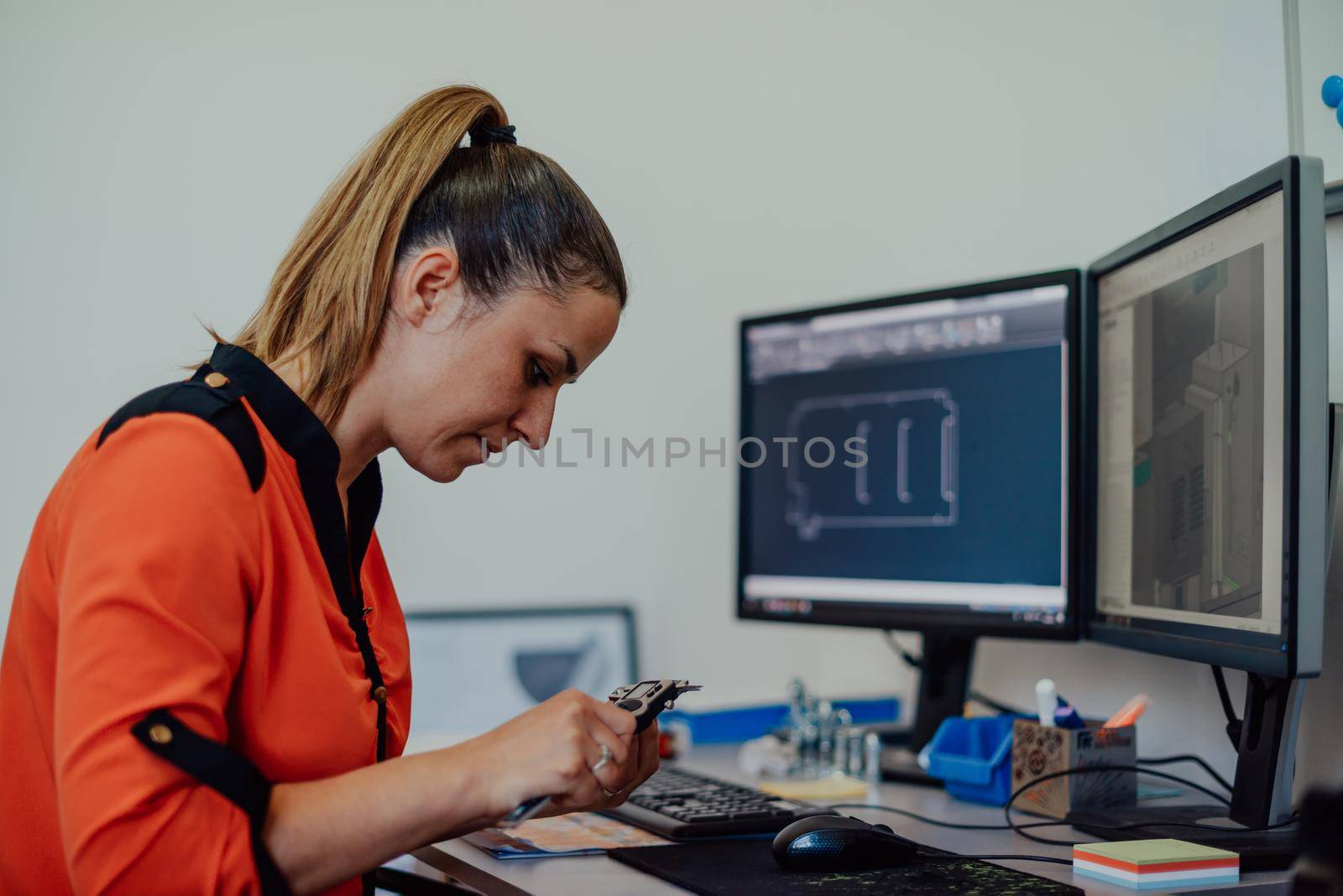 Within the heavy industry, a factory industrial engineer measures with a caliper and on a personal computer Designs a 3D model. High quality photo