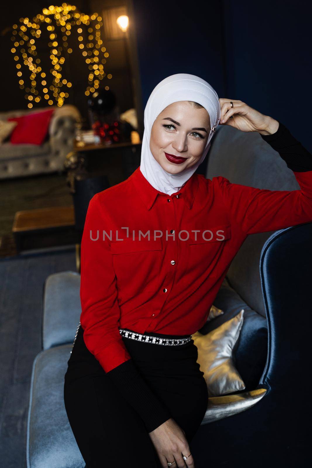 Muslim woman near christmas decoration in studio. Professional muslim model posing at the new year eve.