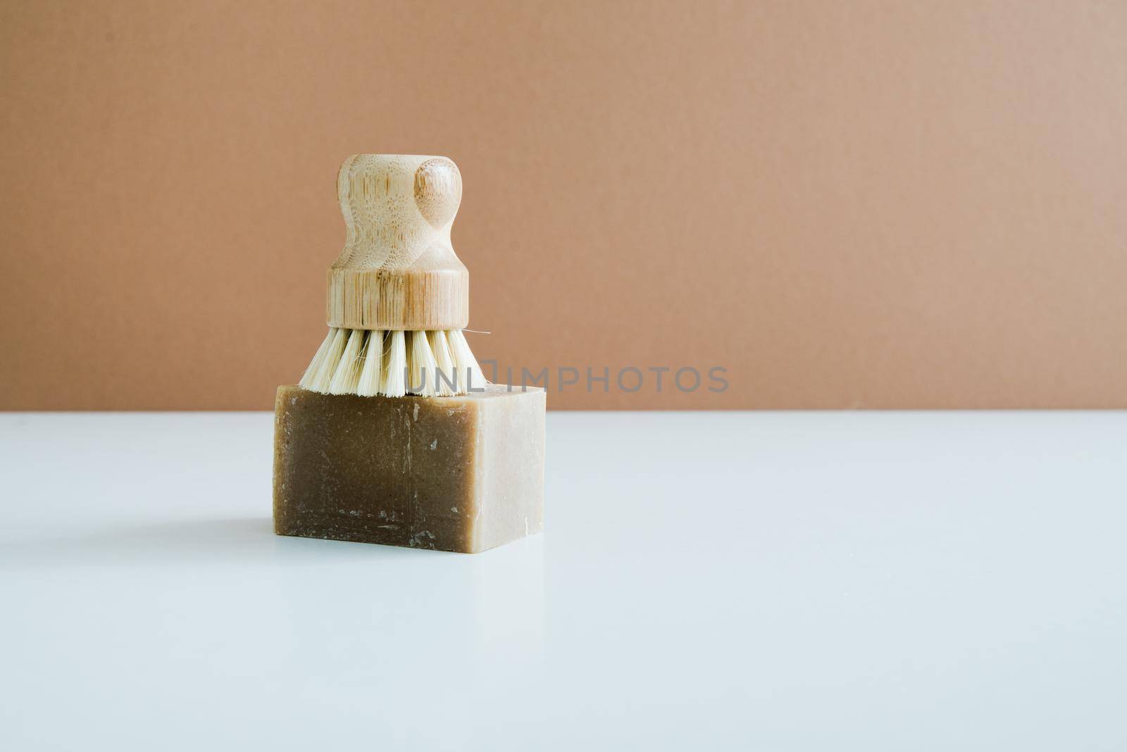 zero waste bamboo brush with soap for dishwashing in minimalistic style. High quality photo