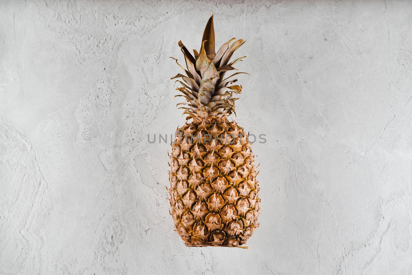 Pineapple tropical fruit on white stone background background. Citrus fruit with vitamin c for helth care. by Rabizo