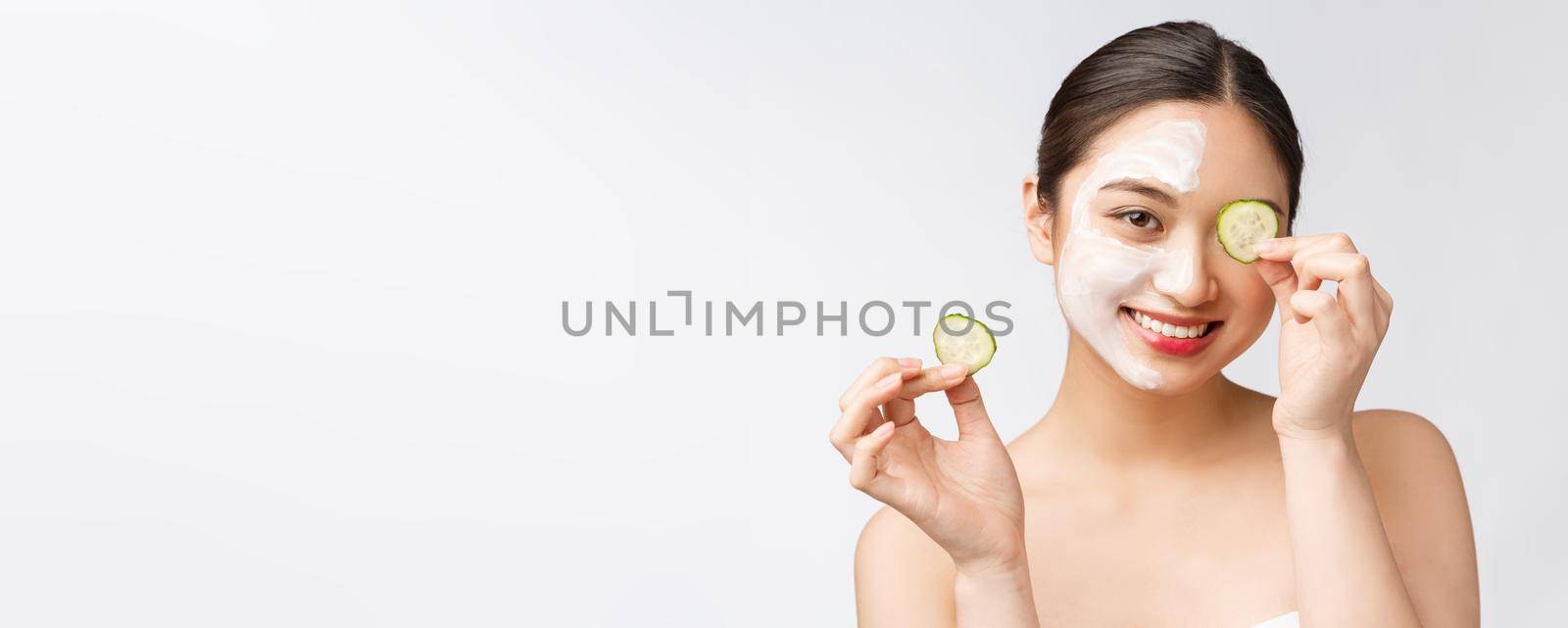 Beauty young asian women skin care image with cucumber on white background studio.