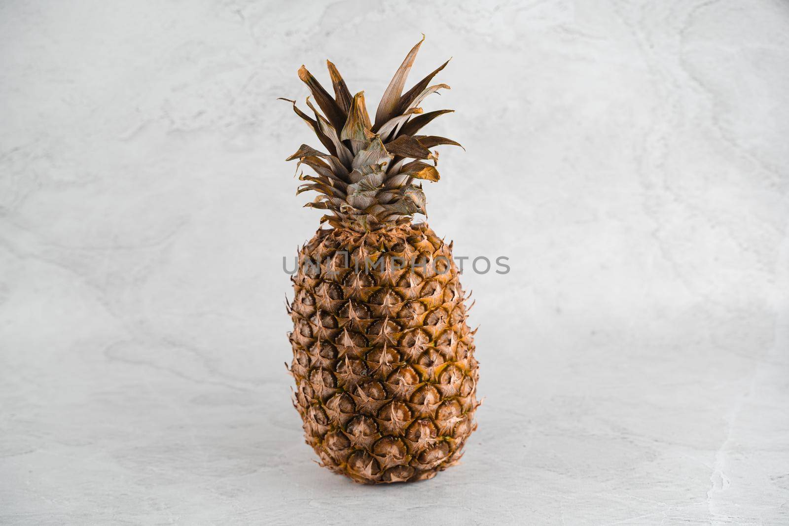 Pineapple tropical fruit on white stone background background. Citrus fruit with vitamin c for helth care. by Rabizo
