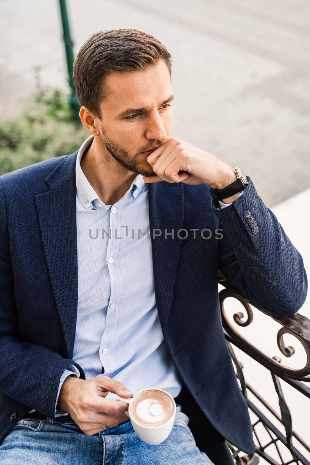 Handsome man with cup of coffee in cafe. Morning lifestyle of male