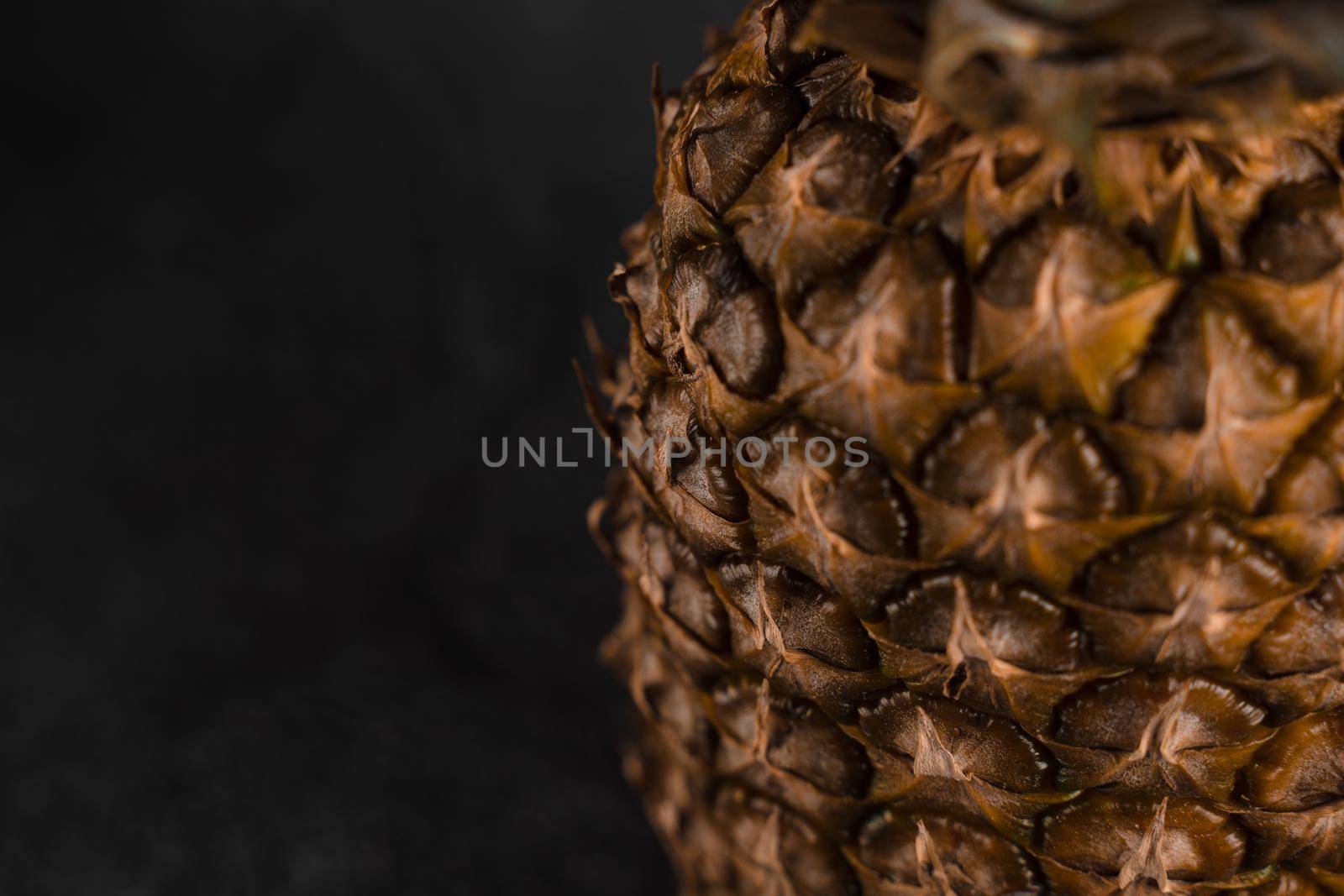 Close-up pineapple tropical fruit on dark stone background background. Citrus fruit with vitamin c for helth care