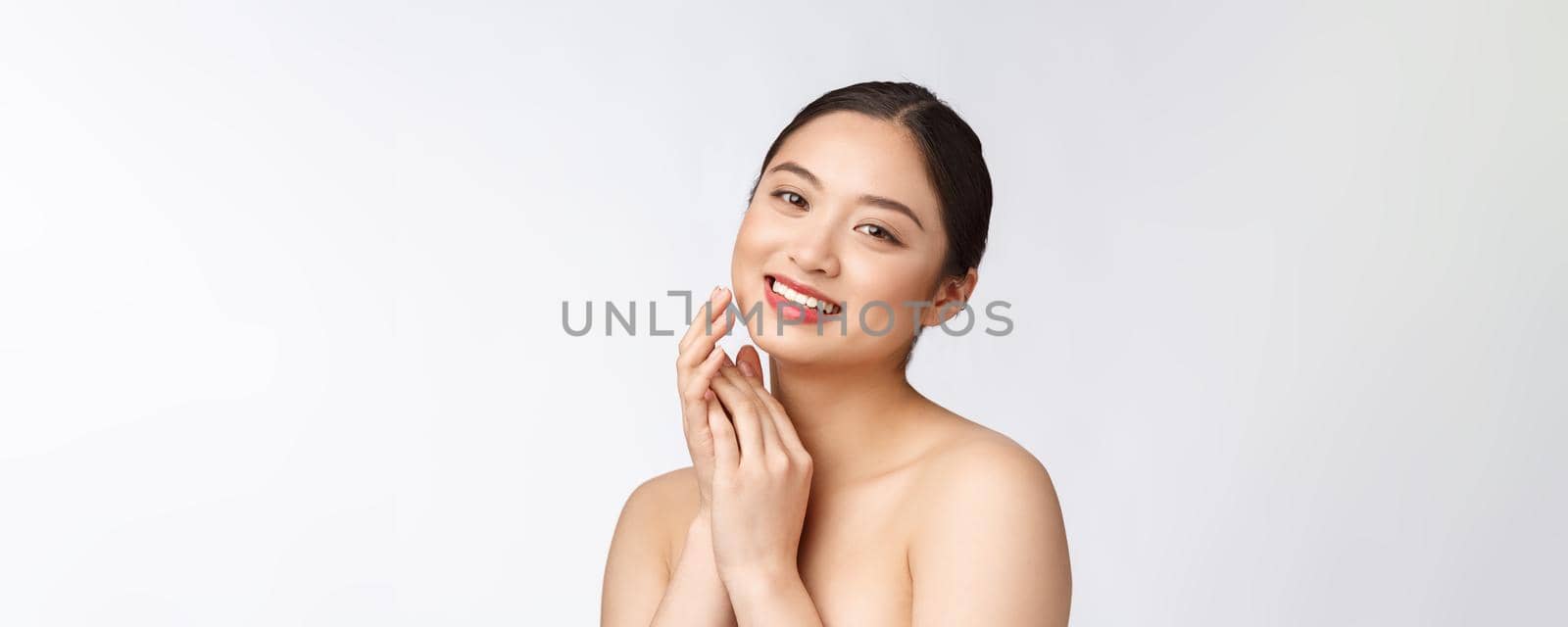 Beautiful asian woman makeup of cosmetic, girl hand touch cheek and smile, face of beauty perfect with wellness isolated on white background