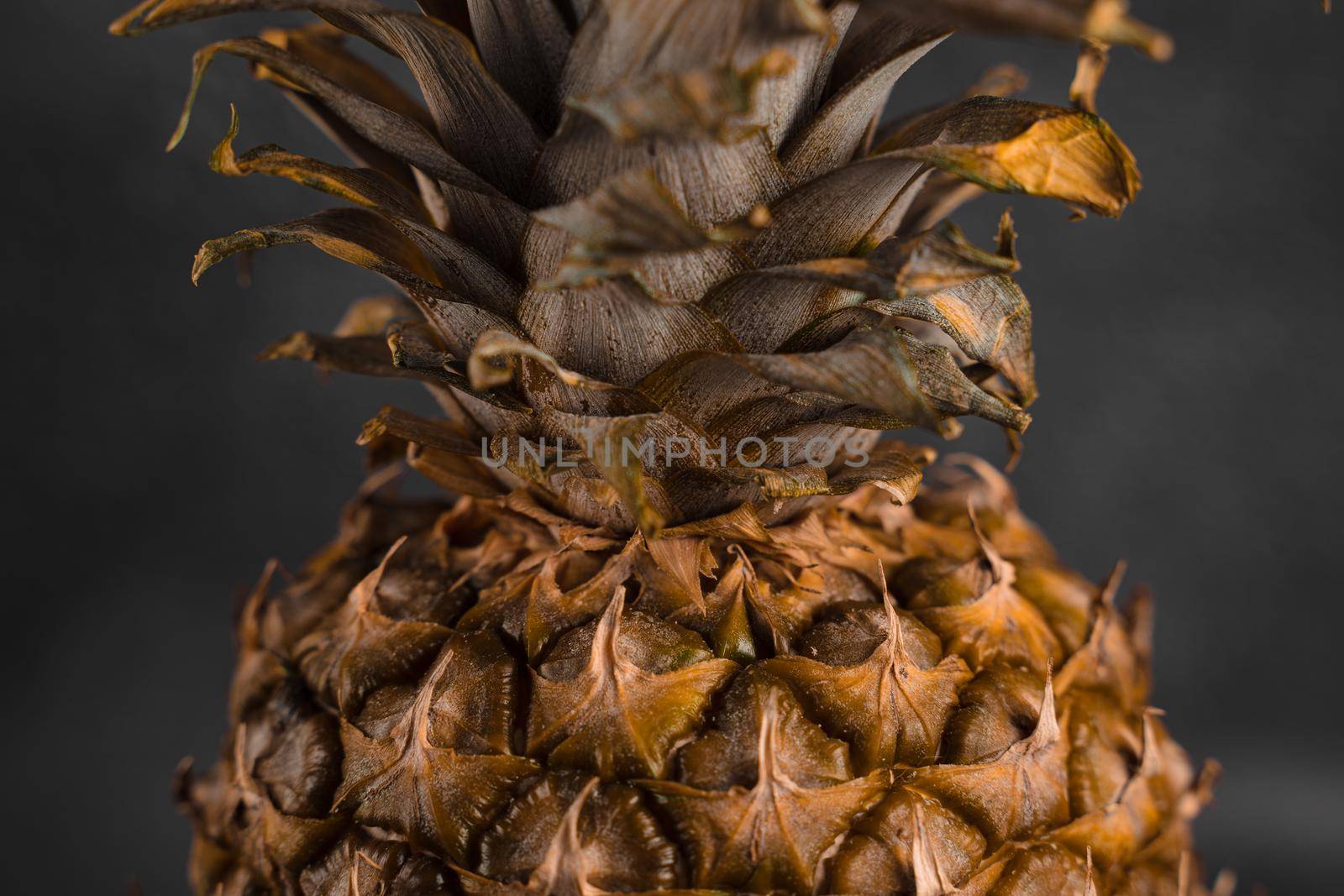 Pineapple tropical fruit on dark stone background background. Citrus fruit with vitamin c for helth care. by Rabizo