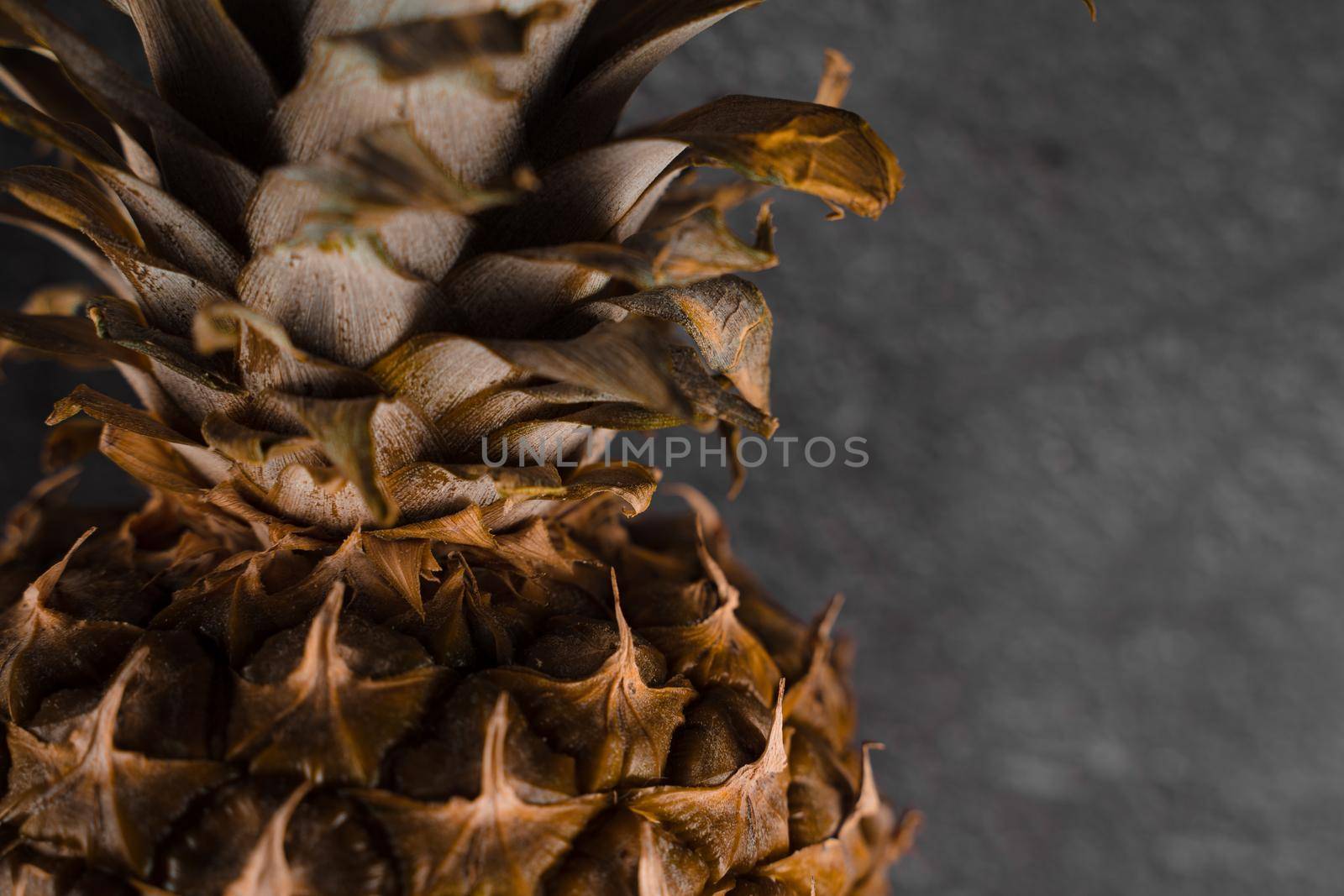 Close-up pineapple tropical fruit on dark stone background background. Citrus fruit with vitamin c for helth care