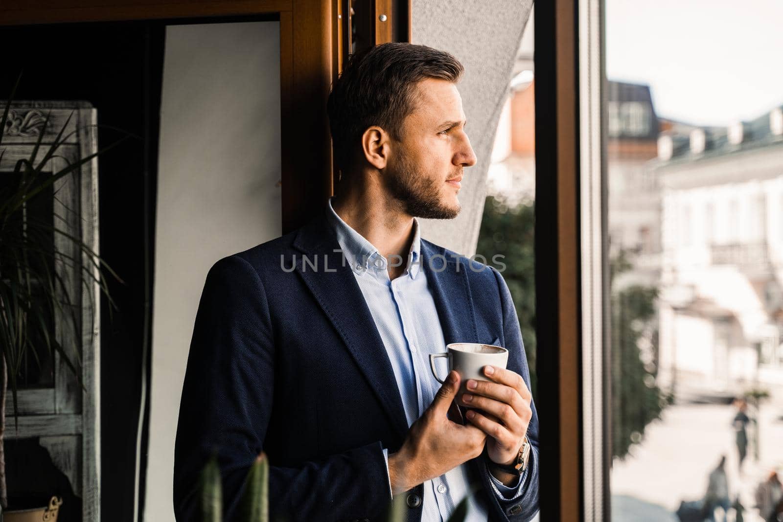 Business man weared suit with cup of coffee in cafe. Bearded man lifestyle