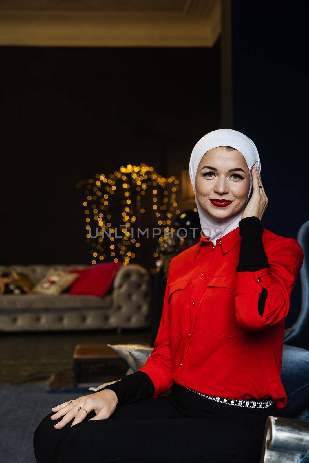 Muslim woman near christmas decoration in studio. Professional muslim model posing at the new year eve.