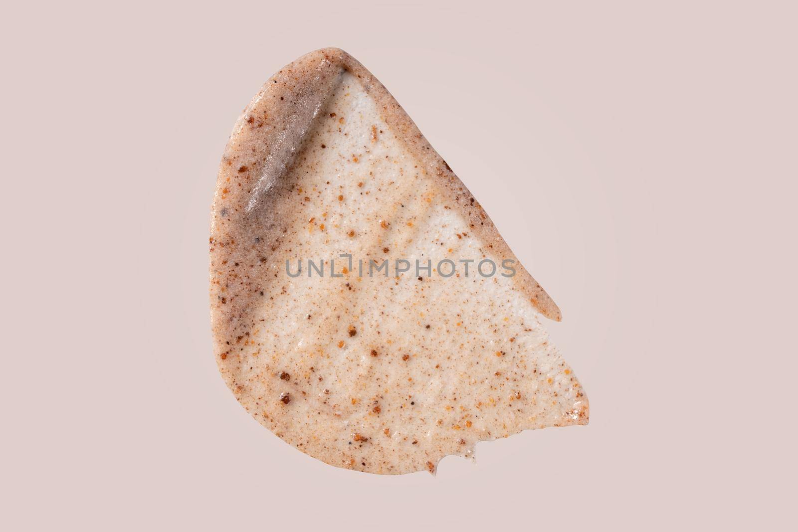 Scrub smear swatch isolated on beige background. Peeling cream smudge with exfoliating particles. Cosmetic skincare product with abrasive particle sample, gentle nude scrub texture. by photolime