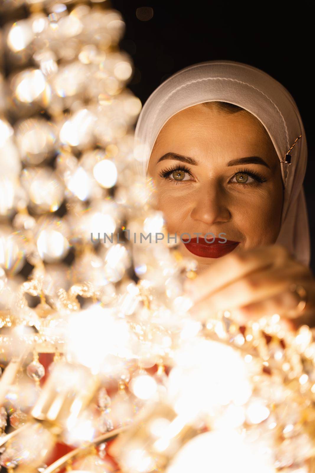 Fashion muslim model near big expensive chandelier. Islamic religion. by Rabizo