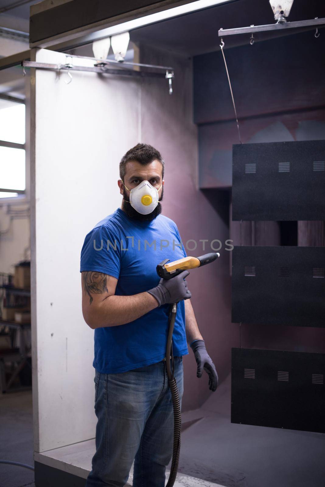 The painter paints the iron element. Industrial painting parts. Metal designs. High-quality photo