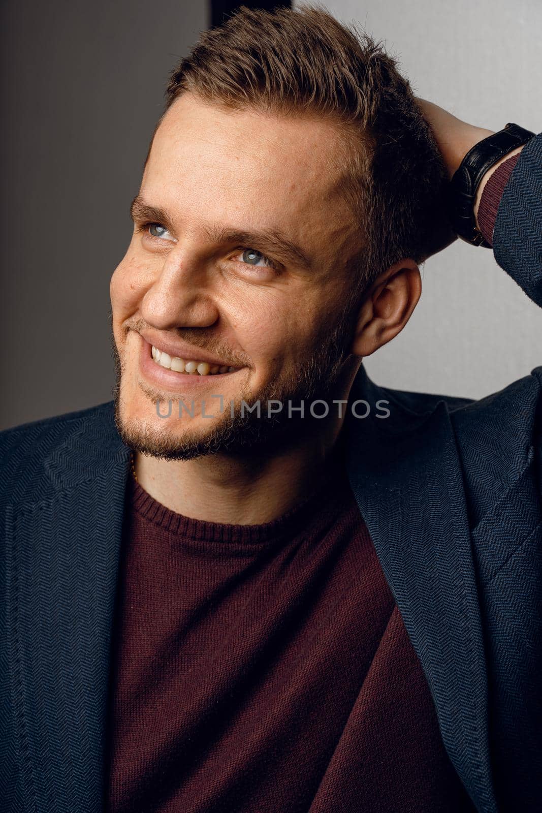 Confident male smiling. Business man portrait on dark background. Handsome young man weared suit in studio.