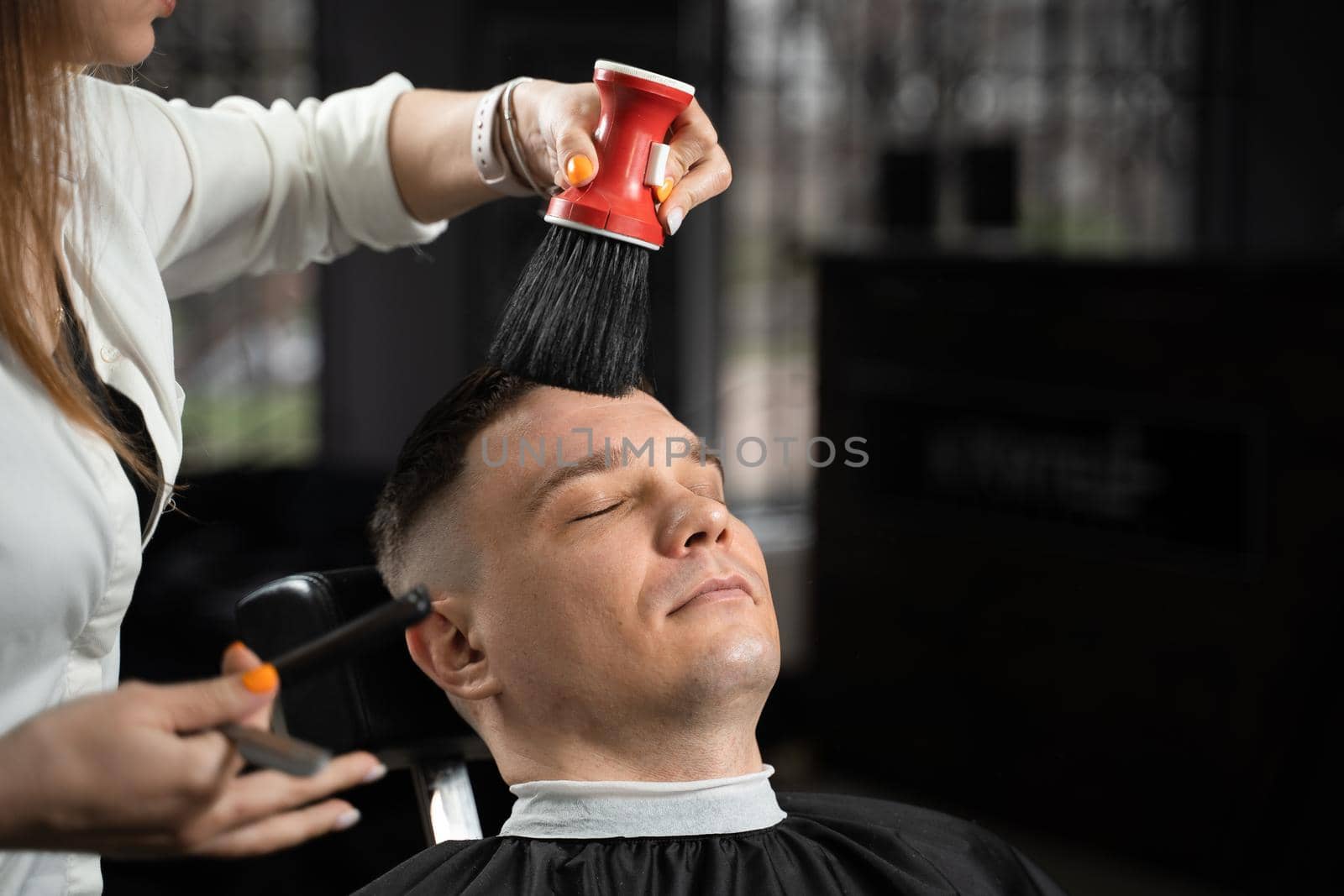 Barbershop service. Cutting hair. Hairstyle for handsome man