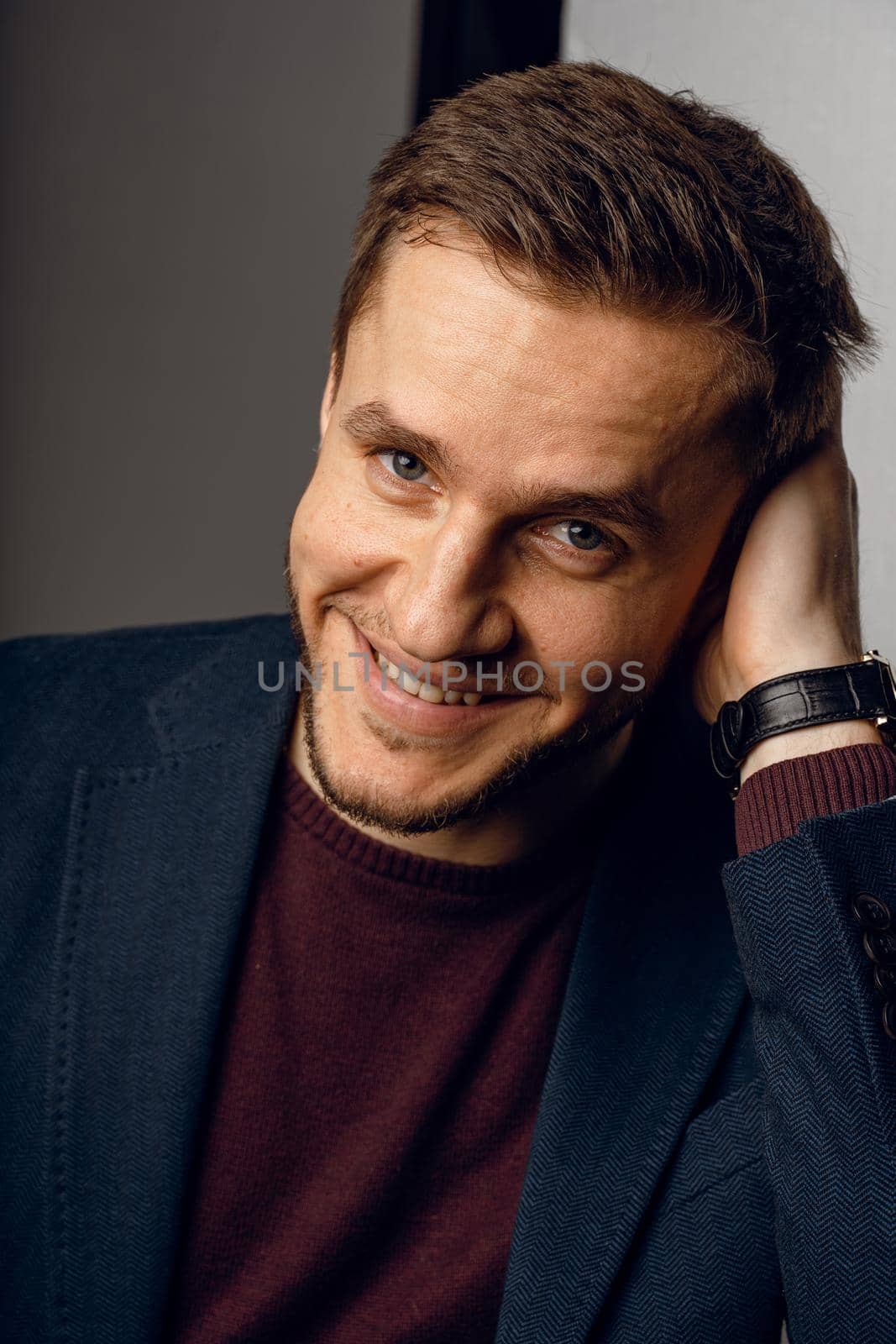 Confident male smiling. Business man portrait on dark background. Handsome young man weared suit in studio.