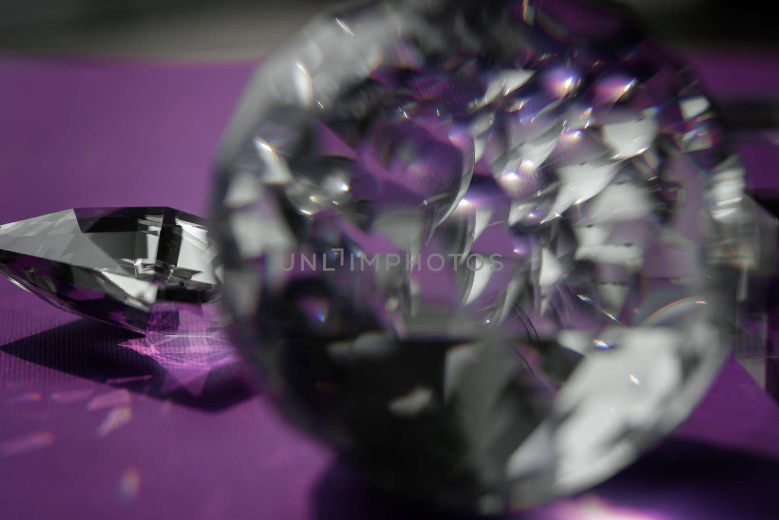 Crystal prism refracting light, magic crystals and pyramid, sphere and cube on purple background. Spiritual healing crystal practice. Feng Shui, good energy flow concept background.. by photolime