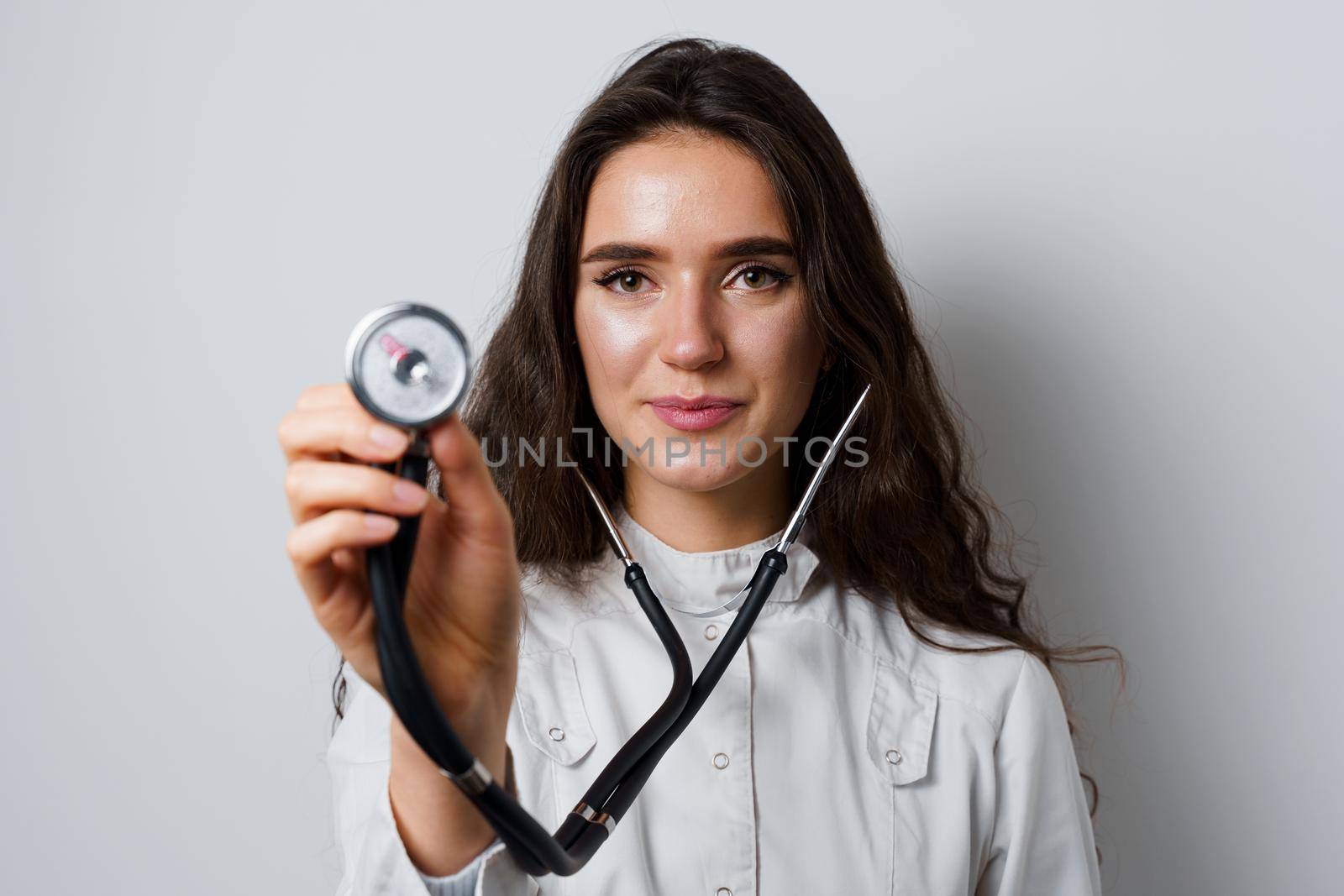 Smiley woman doctor surgeon with stethoscope on white background. Professional medecine. advert for medical clinic