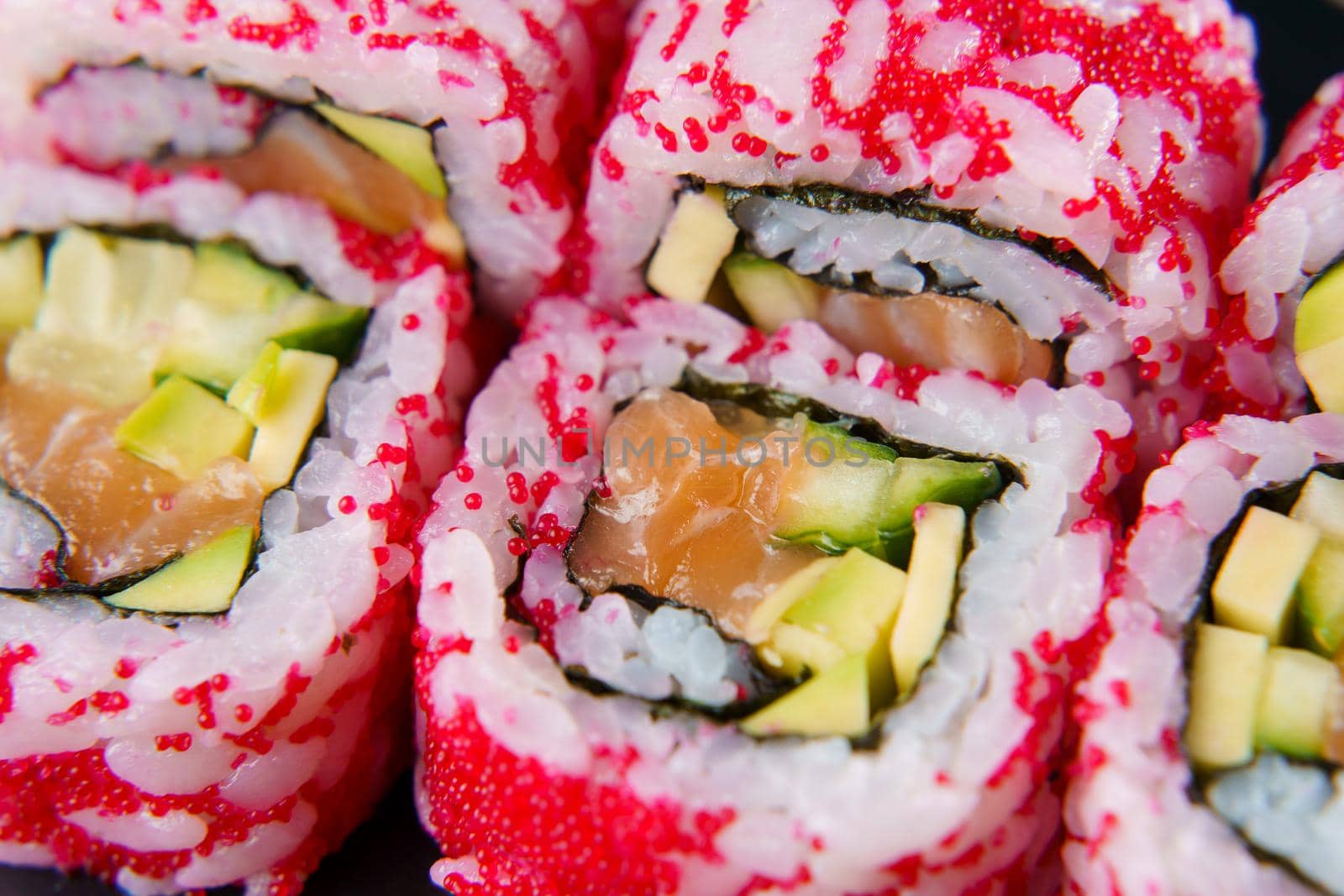 California rolls with caviar, salmon and avocado, cucumber, nori close-up