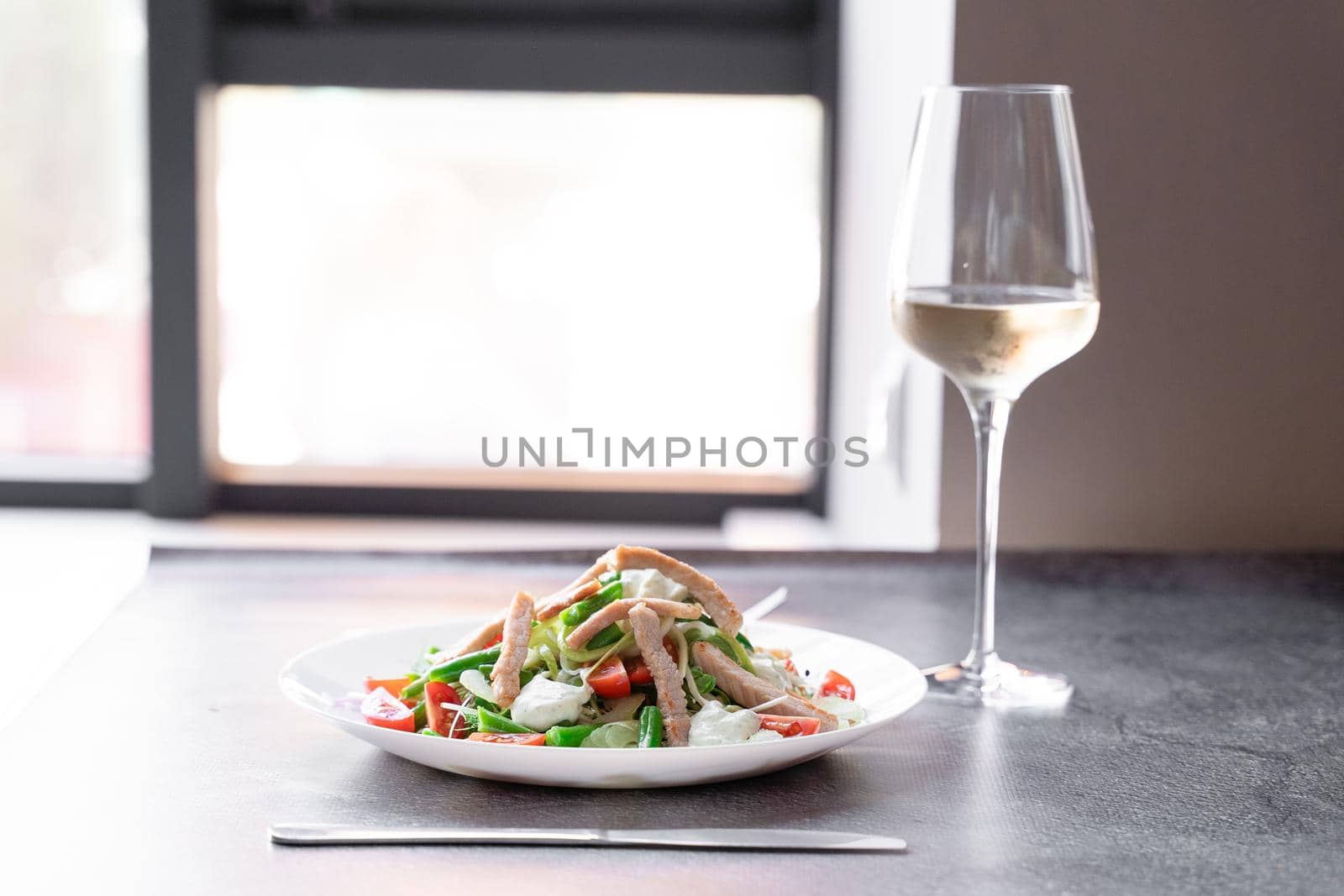 Caesar salad with chicken and parmesan, cherry tomato, lettuce, croutons and egg,