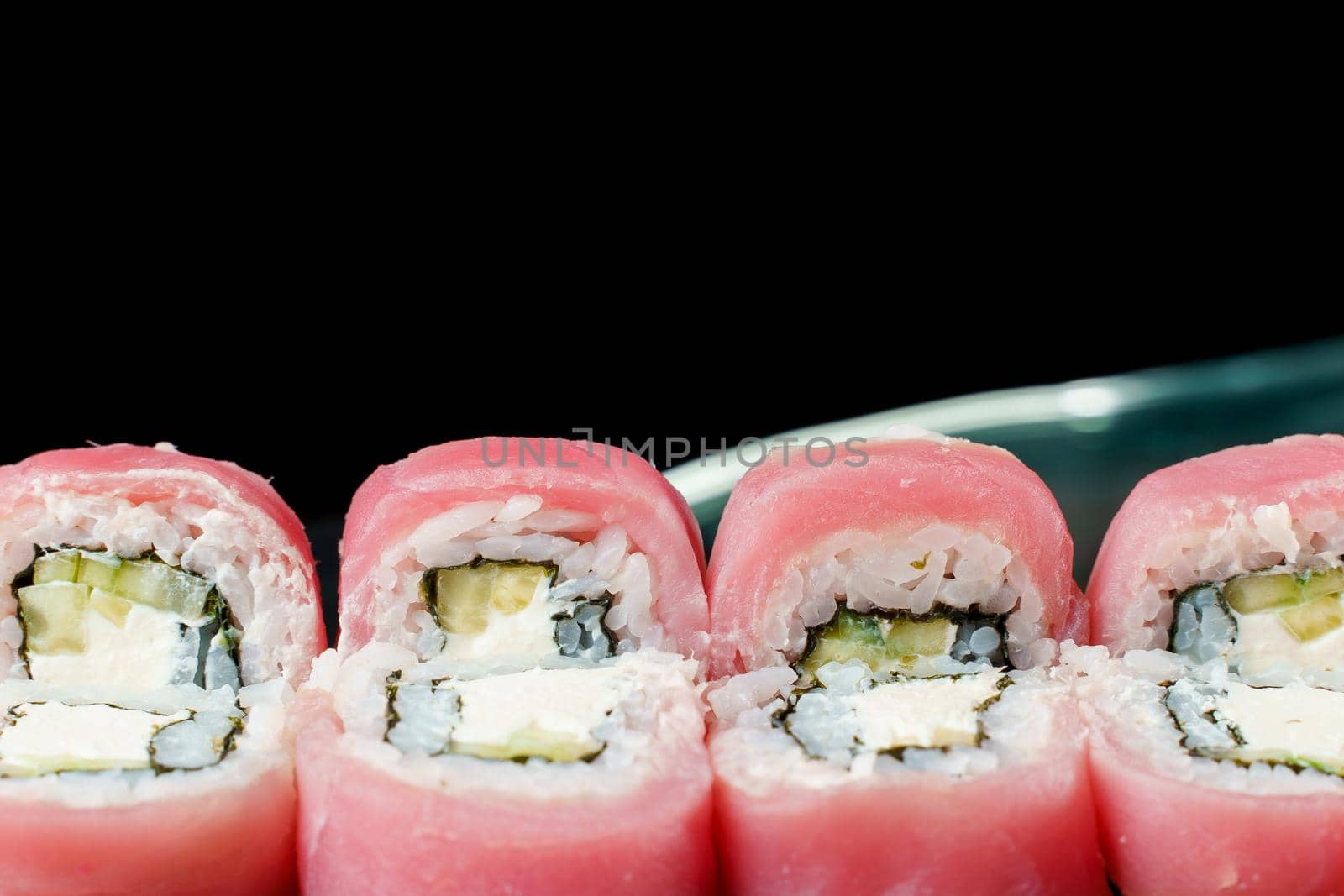 Rolls with tuna, avocado, cucumber, cream cheese, nori close-up. Traditional Japanese cuisine