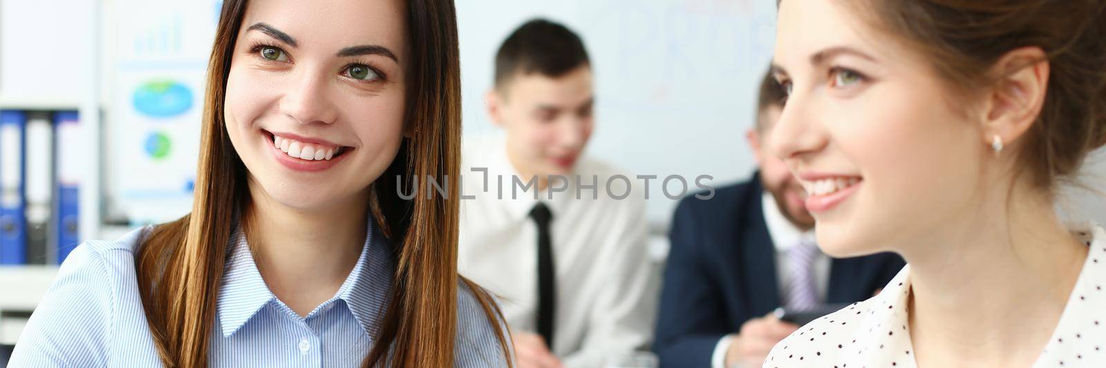 Portrait of gorgeous woman sitting in big modern building and talk about new business strategy by kuprevich