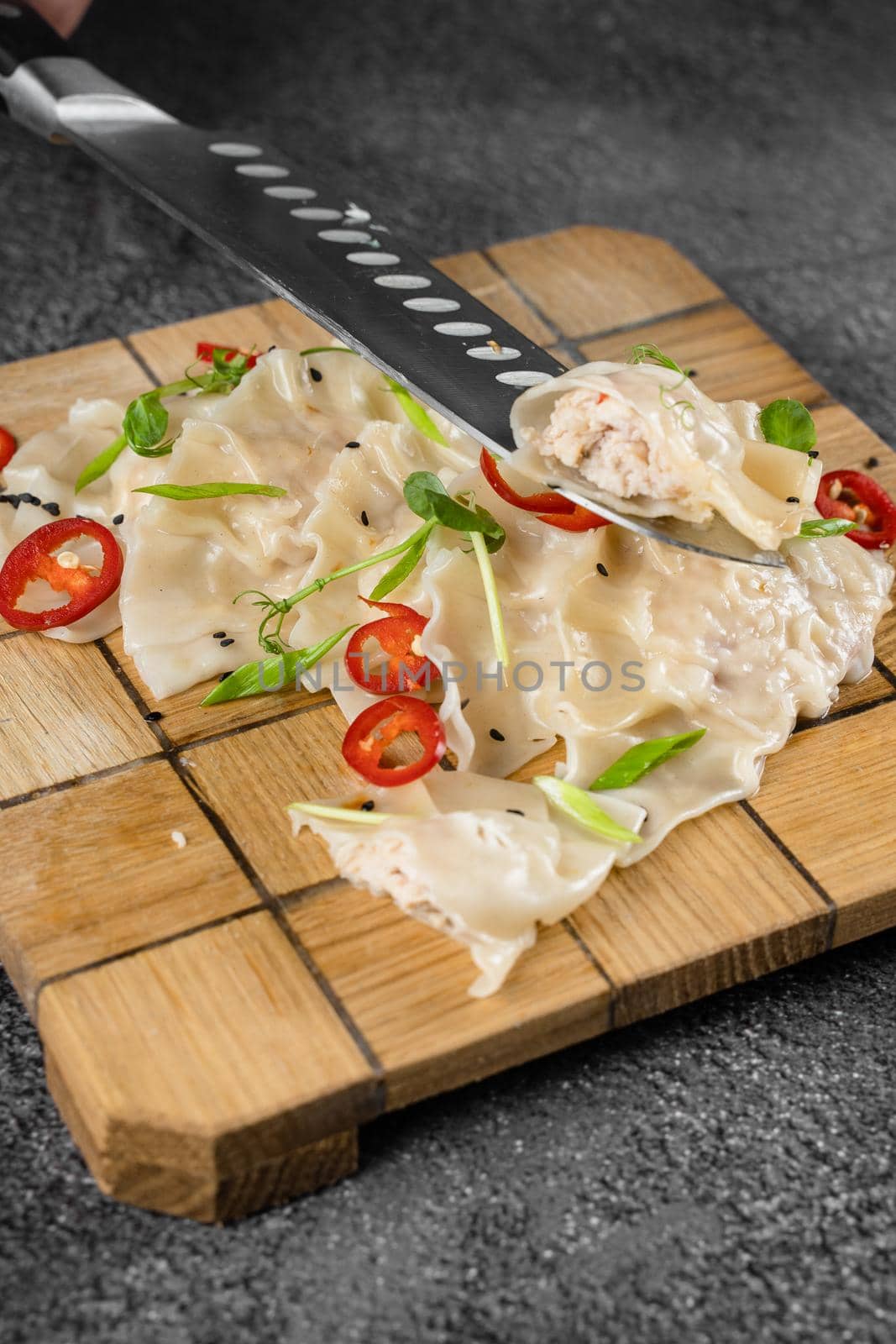 Jiaozi chinese dumplings named gyoza on wooden plate. Asian traditional fast food. Dough dish stuffed with meat and vegetables, less often only meat