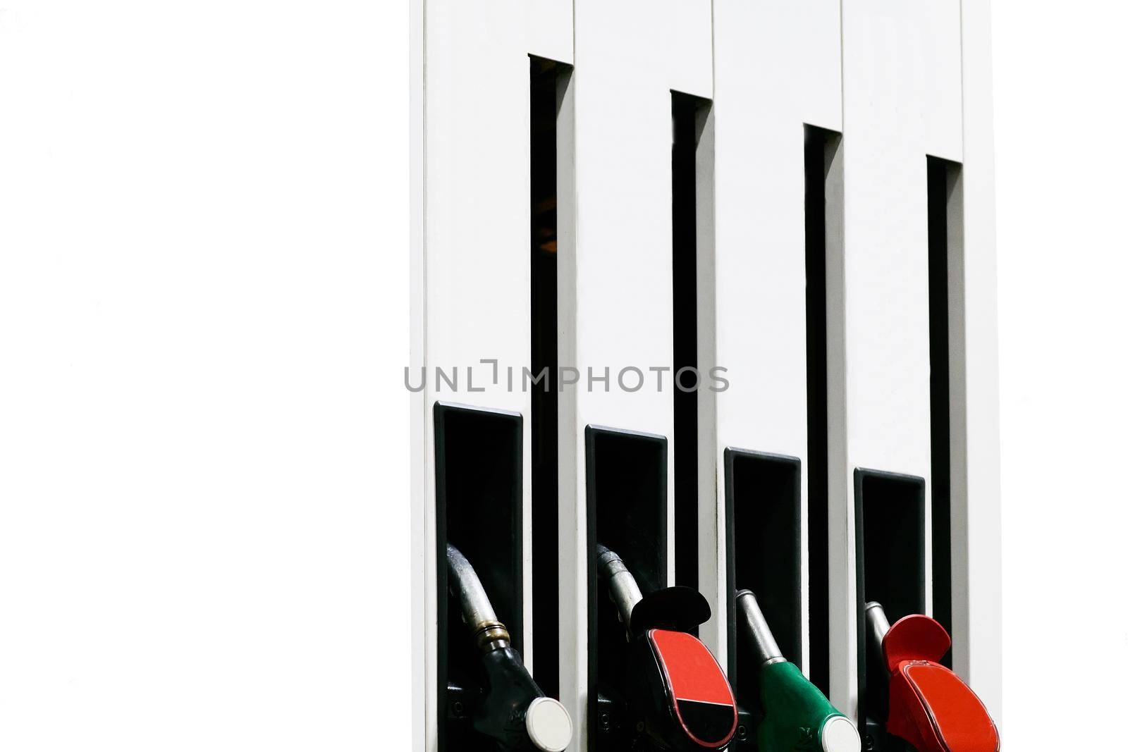 A refueling gun wakes up a gray car at a gas station. A filling station is a facility that sells fuel and engine lubricants for motor vehicles. A refueling gun wakes up a gray car at a gas station.