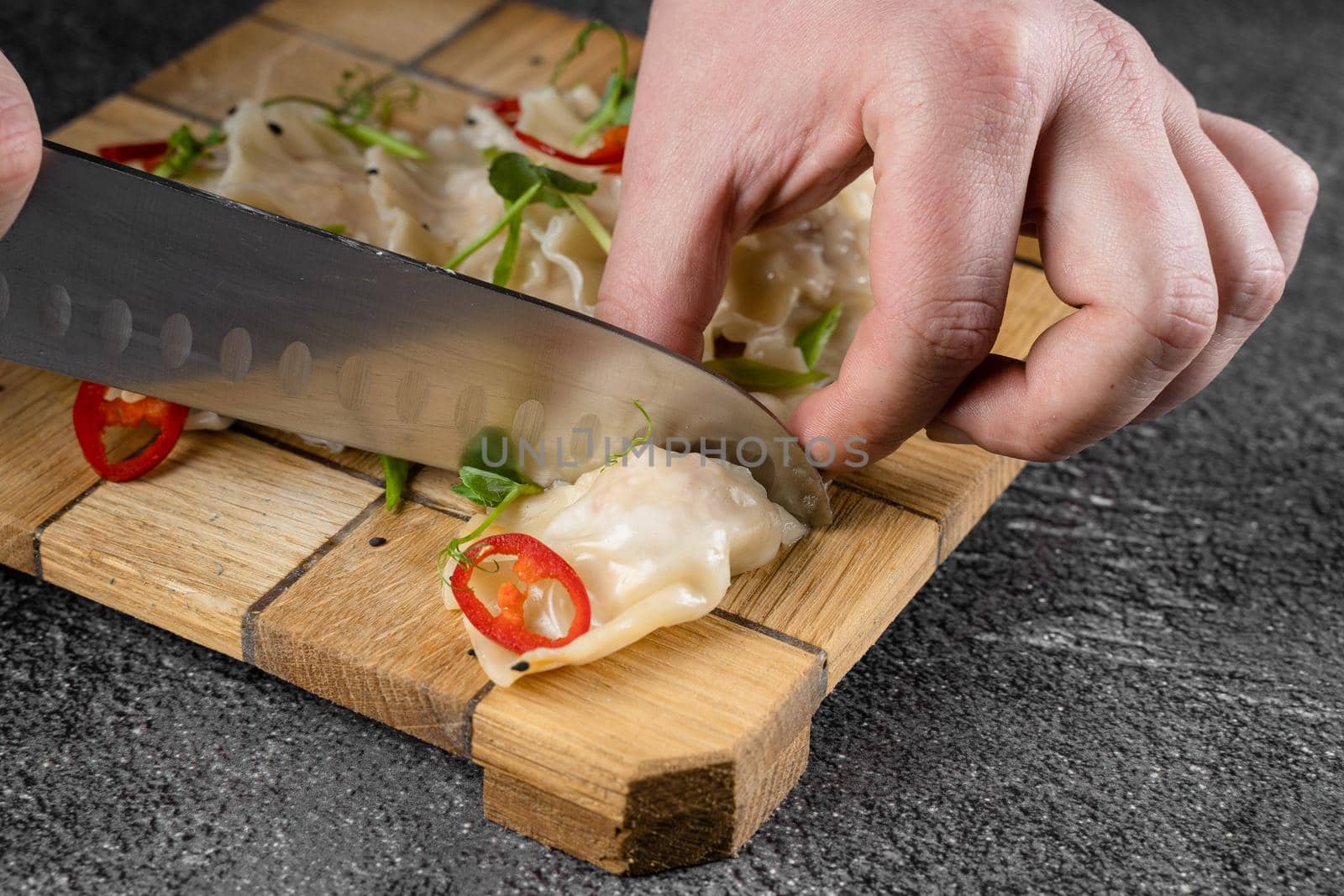 Jiaozi chinese dumplings named gyoza on wooden plate. Asian traditional fast food. Dough dish stuffed with meat and vegetables, less often only meat. by Rabizo