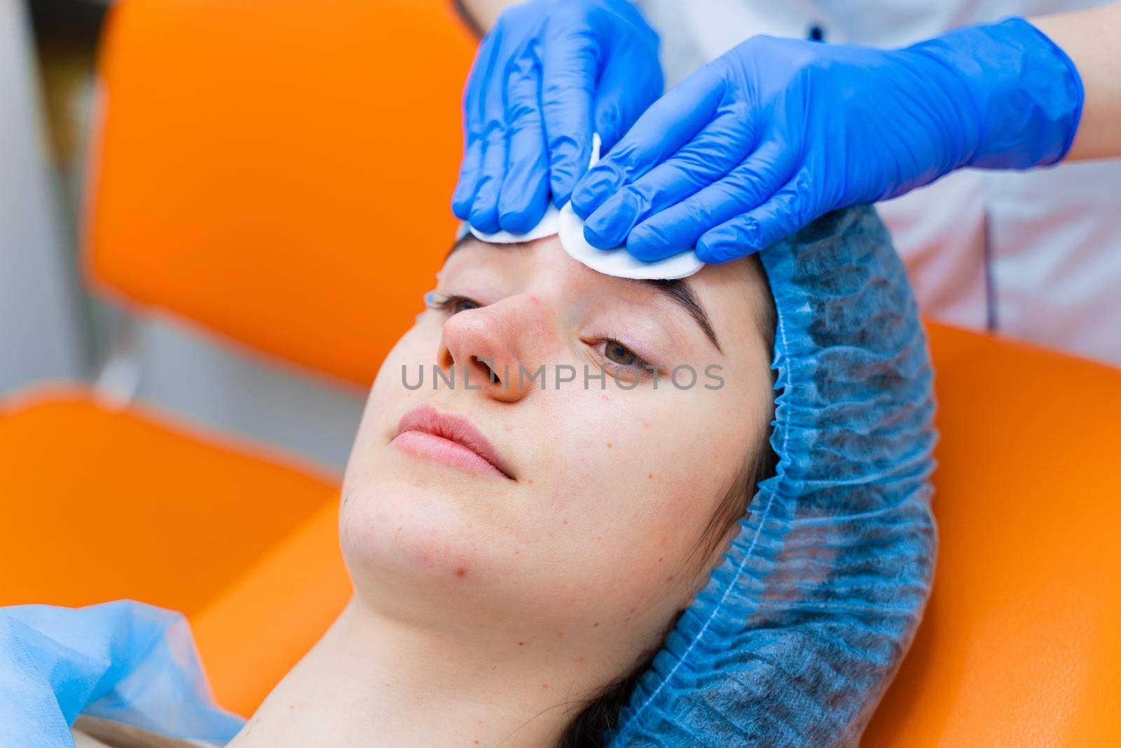 Spa procedure. Facial massage and spreading cream. Cosmetic skin care, by Rabizo