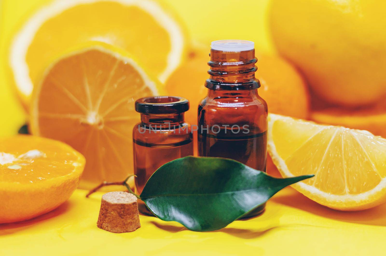 orange essential oil on a yellow background. Selective focus.nature