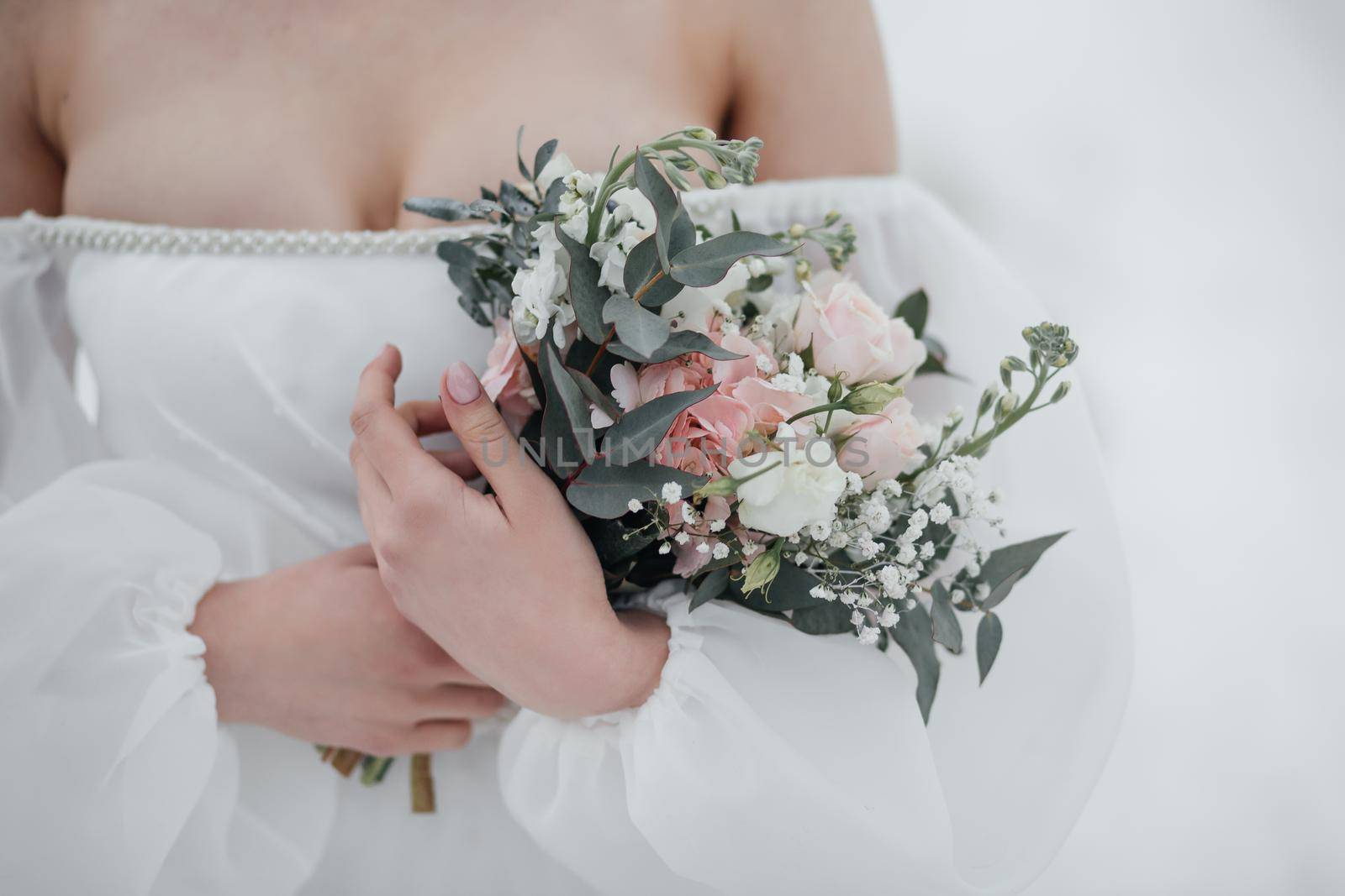 Wedding bouquet in the hands of the bride.