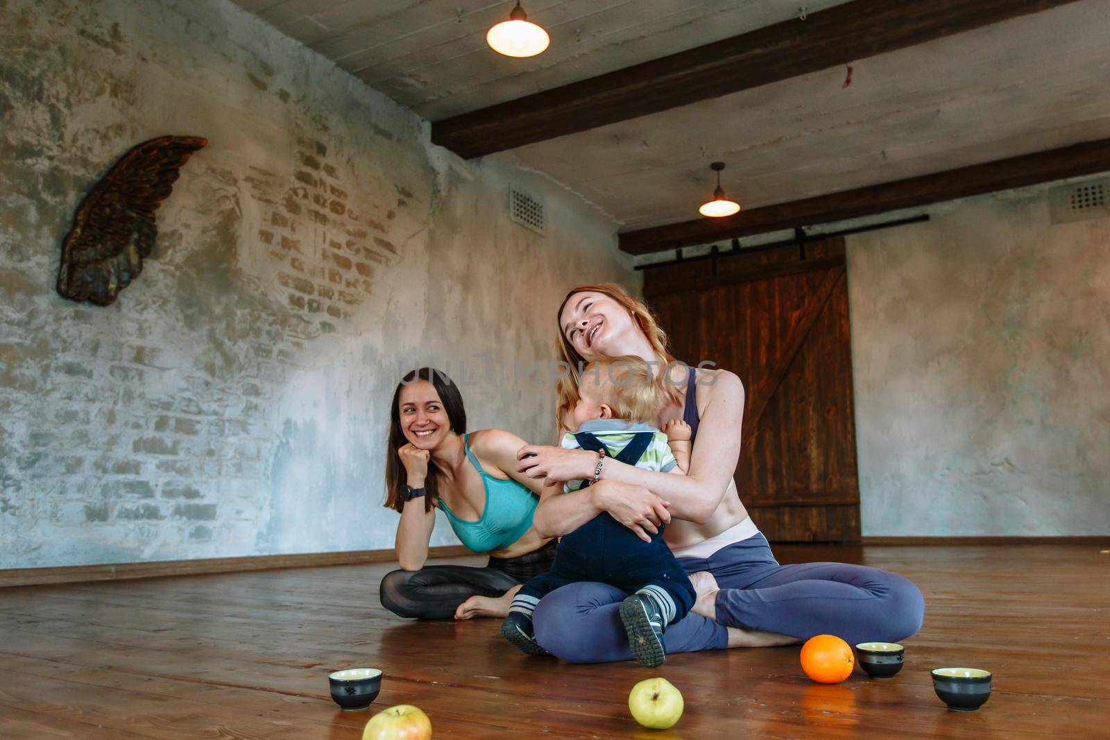 Conversation and tea with two yogis in the loft. A child playing next to the yogis by deandy