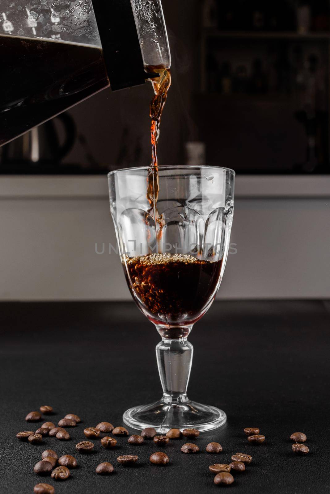 Alternative method of making coffee. coffeemaker is a manual pour-over style glass. Cofee brewing on black background. by Rabizo