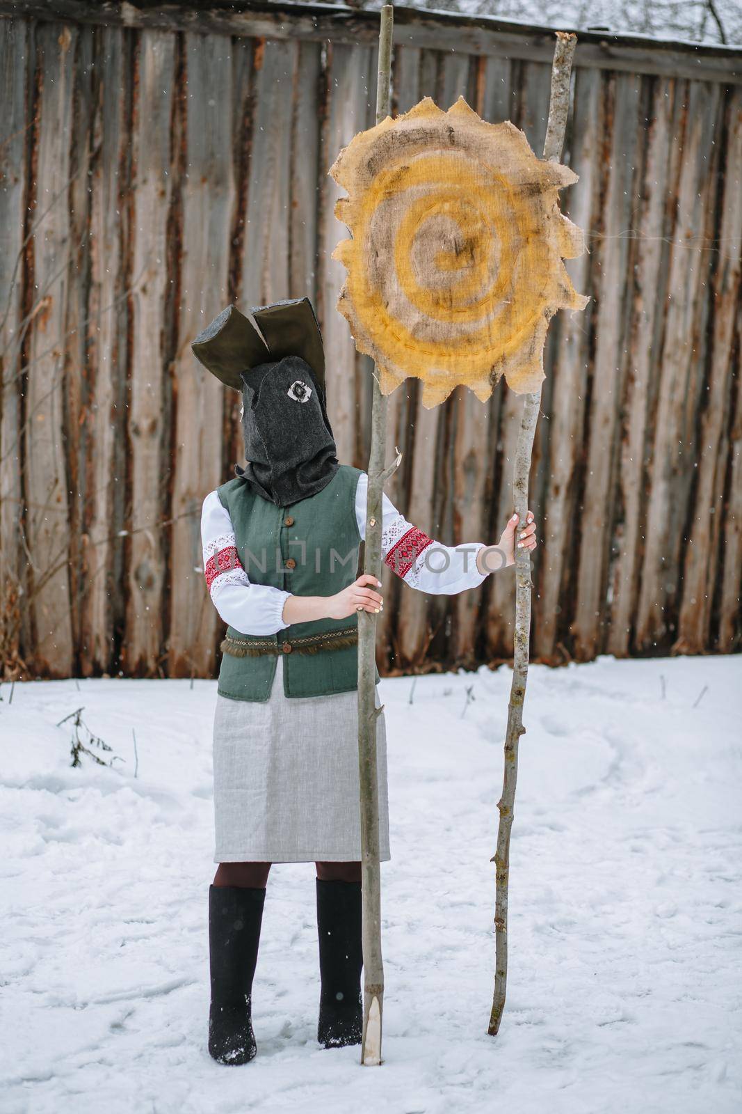 A man in a national costume with the head of an animal celebrates the arrival of the pagan holiday Maslenitsa.