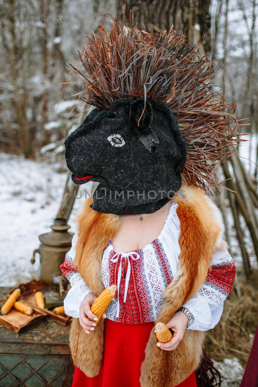 A man in a national costume with the head of an animal celebrates the arrival of the pagan holiday Maslenitsa.
