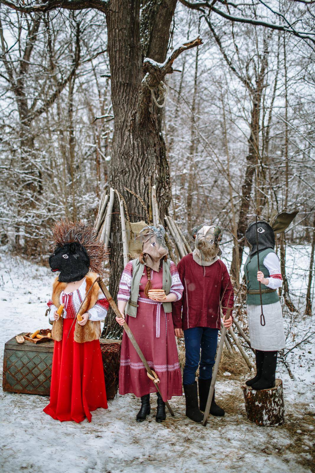 People in national costumes with animal heads celebrate the arrival of the pagan holiday Maslenitsa. An ancient pag by deandy