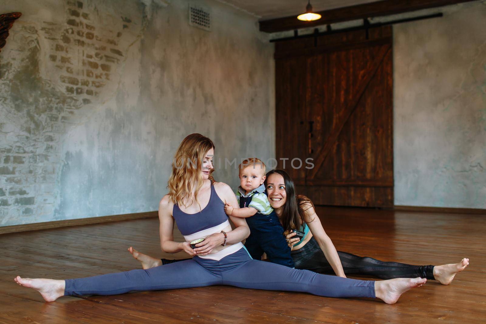 Conversation and tea with two yogis in the loft. A child playing next to the yogis by deandy