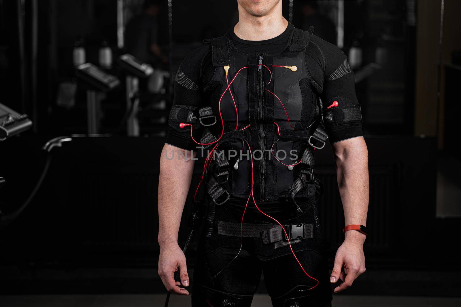 EMS suit with red wires for electro impulse stimulation for body. Training in GYM. by Rabizo