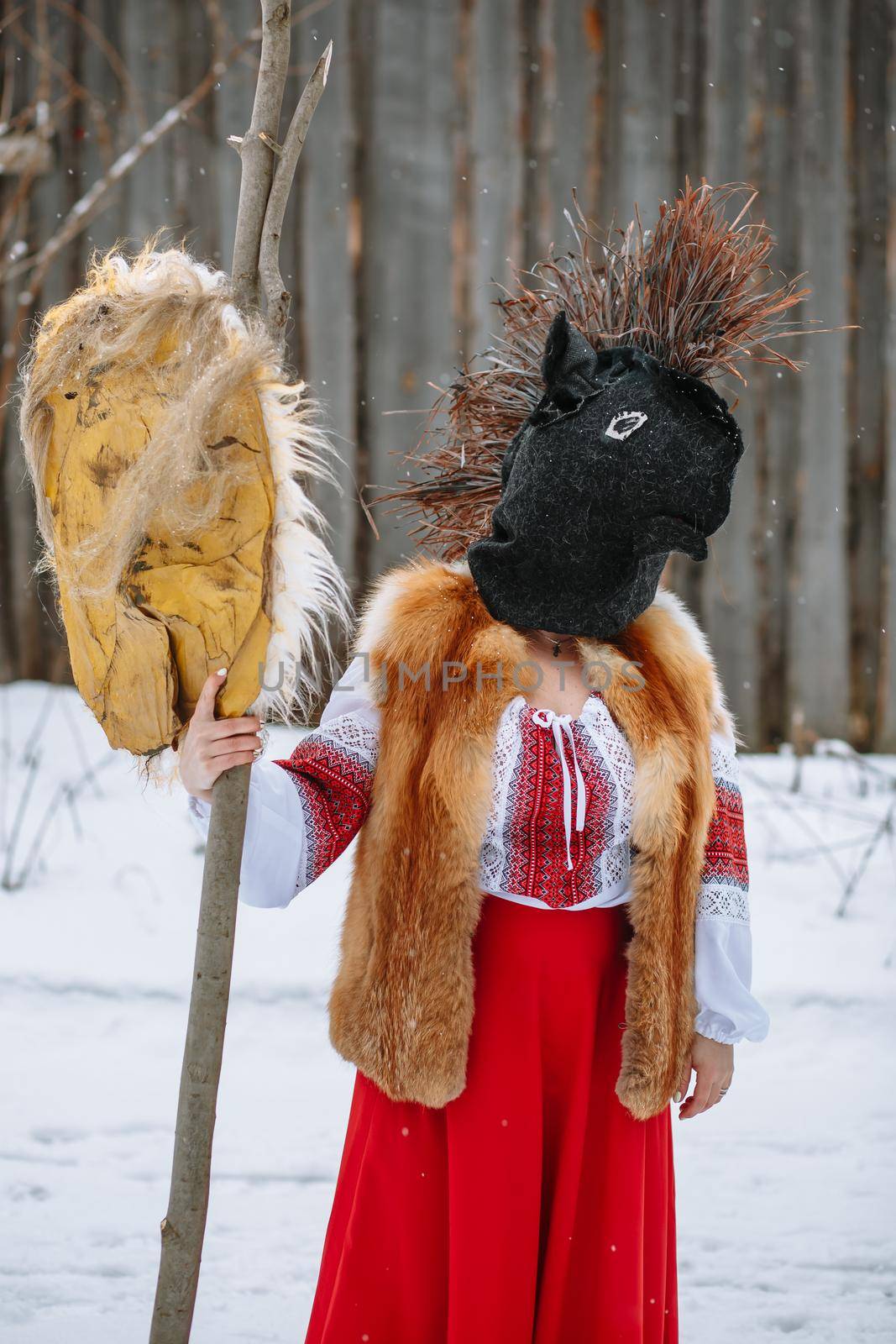 A man in a national costume with the head of an animal celebrates the arrival of the pagan holiday Maslenitsa.