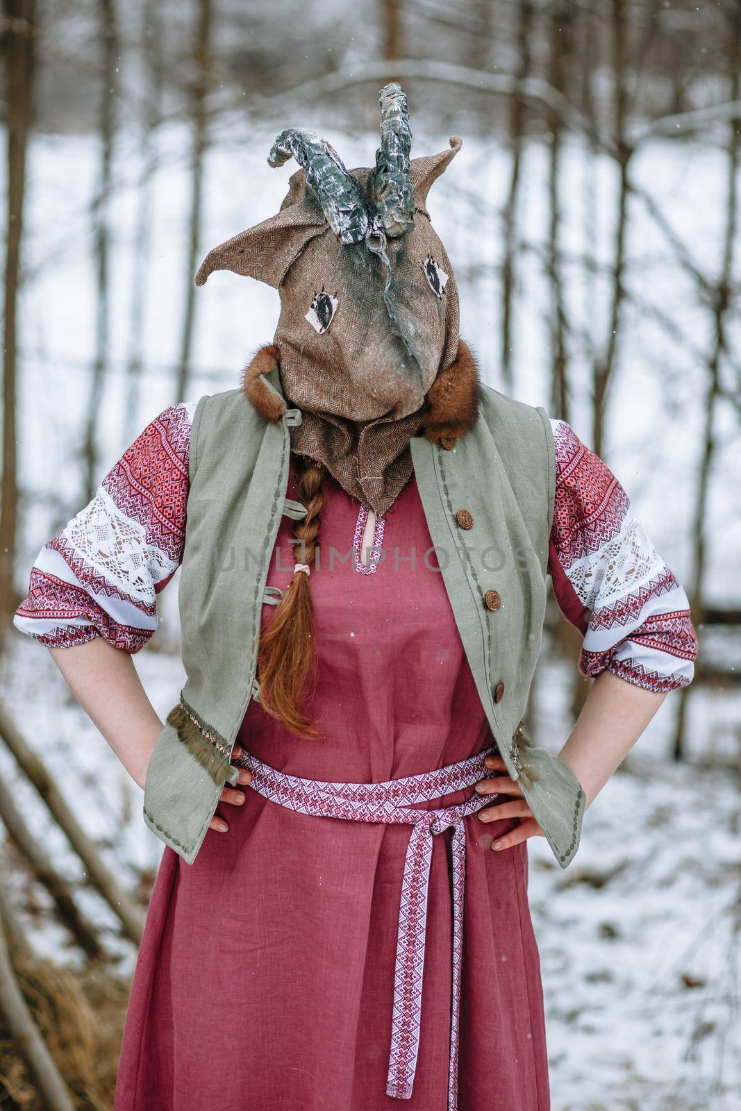 A man in a national costume with the head of an animal celebrates the arrival of the pagan holiday Maslenitsa.