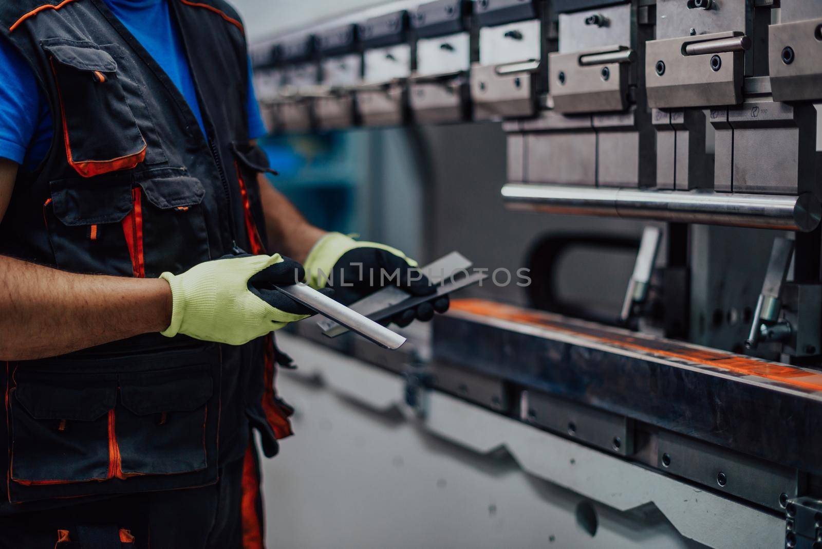 A smart factory worker or engineer makes machines in a production workshop. The concept of industry and engineering. Selective focus. High-quality photo