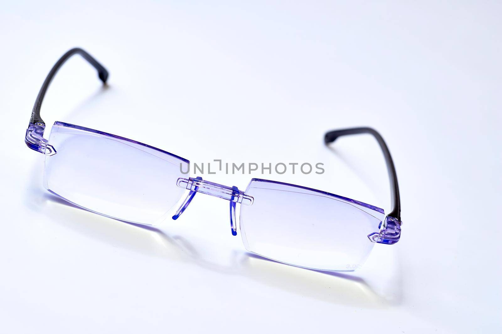 a pair of lenses set in a frame resting on the nose and ears, used to correct or assist defective eyesight or protect the eyes.